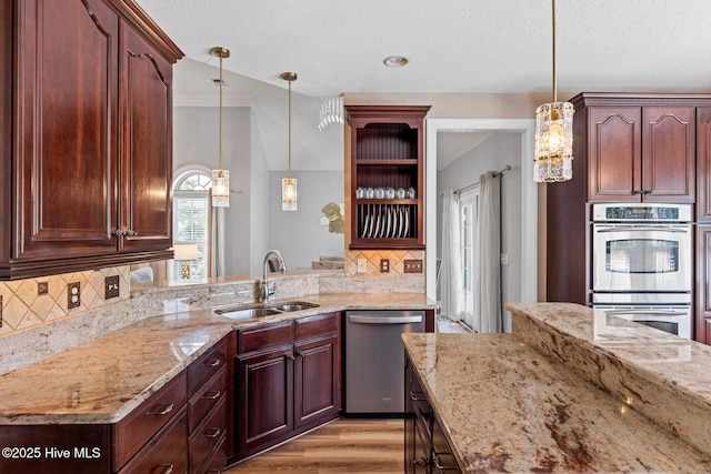 1096 Rutledge Ct NW, Calabash, NC 28467 - kitchen with stainless steel appliances, a sink, light stone countertops, decorative backsplash, and open shelves