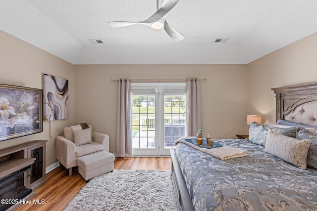 1096 Rutledge Ct NW, Calabash, NC 28467 - bedroom with access to exterior, light wood-style flooring, a ceiling fan, a textured ceiling, and vaulted ceiling