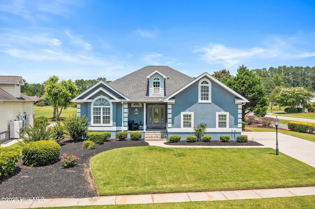 1096 Rutledge Ct NW, Calabash, NC 28467 - traditional-style home featuring covered porch, a front yard, stucco siding, and a shingled roof