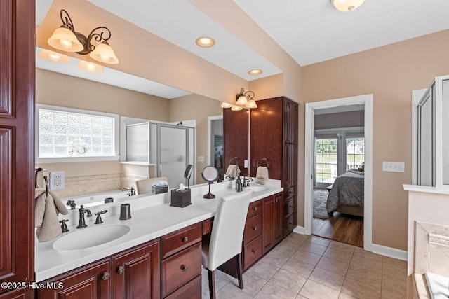 1096 Rutledge Ct NW, Calabash, NC 28467 - ensuite bathroom with a stall shower, double vanity, a garden tub, tile patterned floors, and baseboards