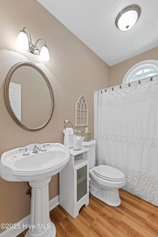 1096 Rutledge Ct NW, Calabash, NC 28467 - bathroom with toilet, wood finished floors, and a shower with curtain