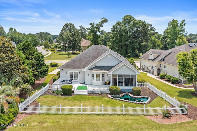 1096 Rutledge Ct NW, Calabash, NC 28467 - back of house featuring a sunroom, a deck, a shingled roof, and an outdoor living space