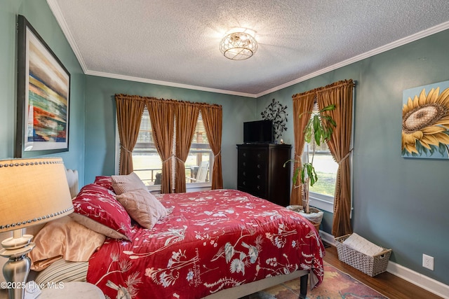 bedroom with baseboards, a textured ceiling, wood finished floors, and crown molding