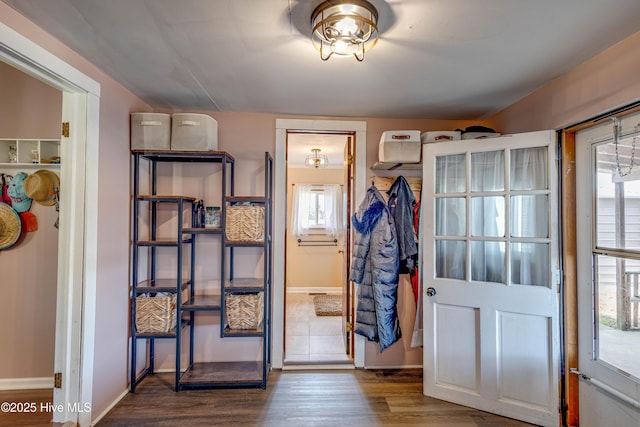 interior space featuring baseboards and wood finished floors