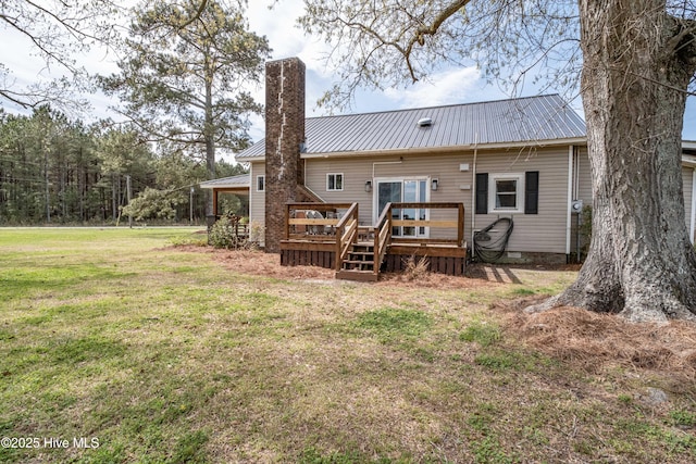 back of house with metal roof, a wooden deck, crawl space, and a yard