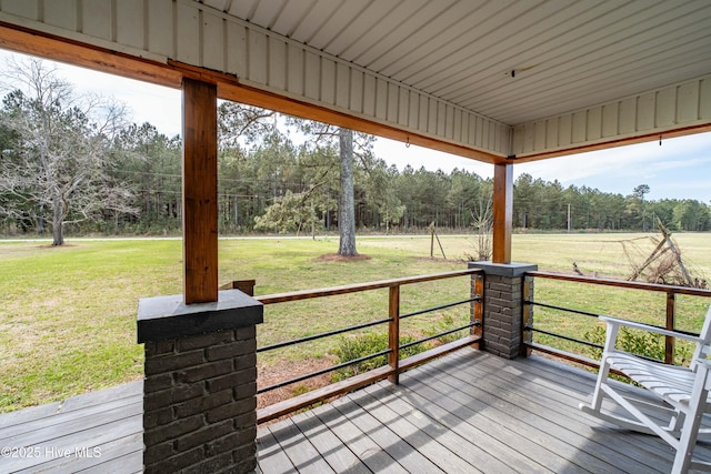 wooden terrace featuring a yard