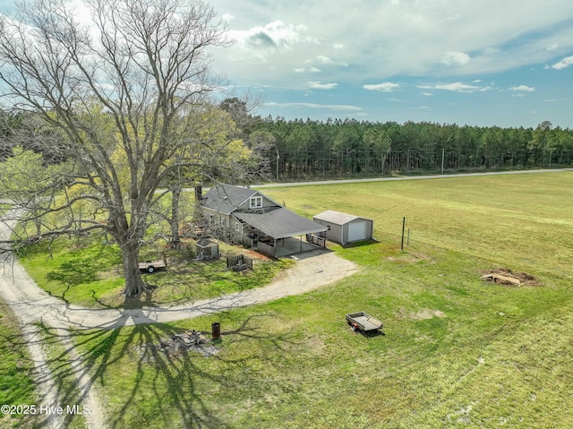 drone / aerial view with a wooded view