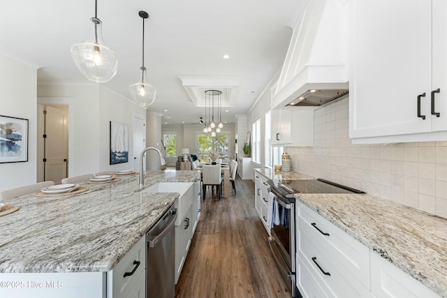 kitchen with premium range hood, tasteful backsplash, white cabinets, and stainless steel appliances