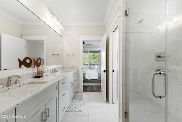 bathroom with double vanity, a sink, a stall shower, and crown molding