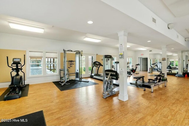 gym featuring decorative columns, visible vents, recessed lighting, and light wood-type flooring