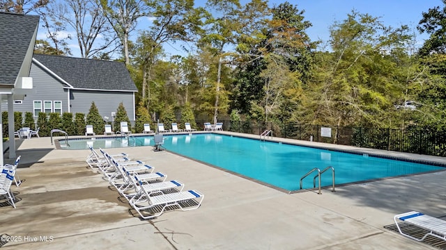 community pool with fence and a patio
