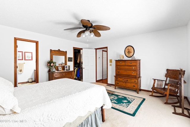 bedroom with ceiling fan, light carpet, connected bathroom, and a closet