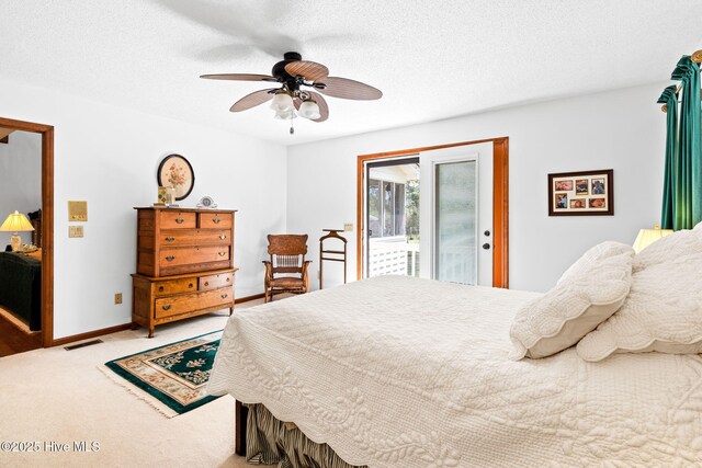 carpeted bedroom with access to exterior, ceiling fan, baseboards, visible vents, and a textured ceiling