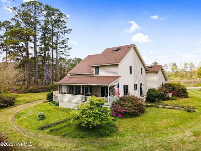 view of front facade featuring a porch, a front lawn, and a shingled roof