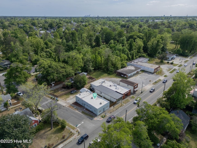 bird's eye view with a wooded view