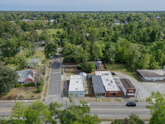 birds eye view of property featuring a wooded view