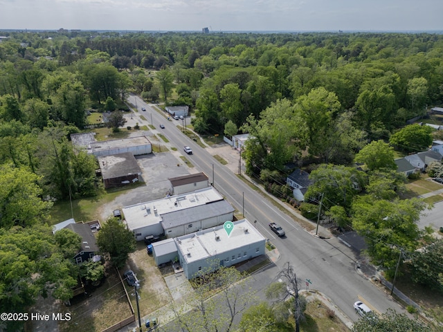 birds eye view of property featuring a wooded view