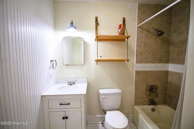 bathroom with toilet, vanity, shower / bathing tub combination, and baseboards