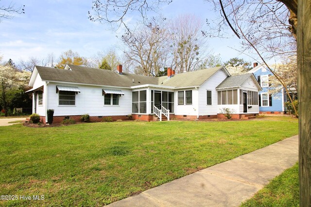 view of front of house with a sunroom, a front lawn, crawl space, and roof with shingles