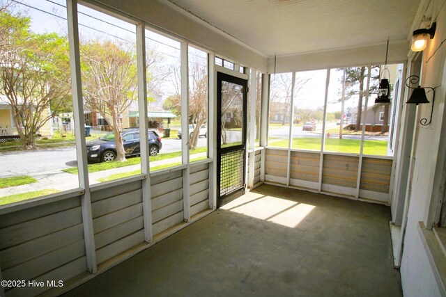 unfurnished sunroom with a residential view