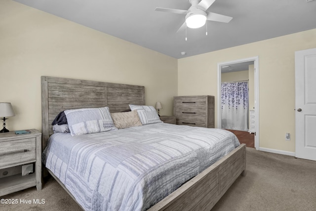 carpeted bedroom with baseboards, ceiling fan, and ensuite bath