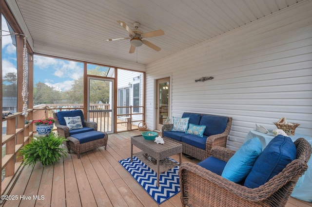 sunroom featuring an outdoor living space and a ceiling fan