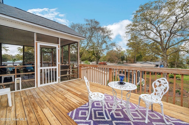 wooden deck with a sunroom