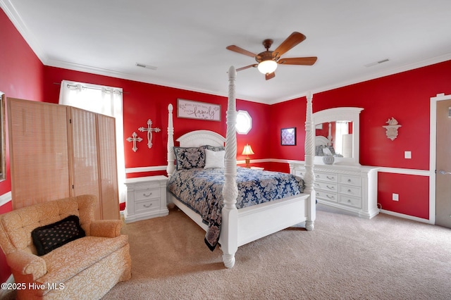 carpeted bedroom with ornamental molding, baseboards, ceiling fan, and visible vents