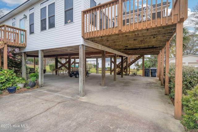 view of patio featuring a carport, stairway, and concrete driveway