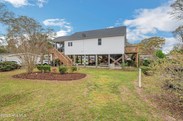 rear view of property with a lawn, stairs, and a patio area