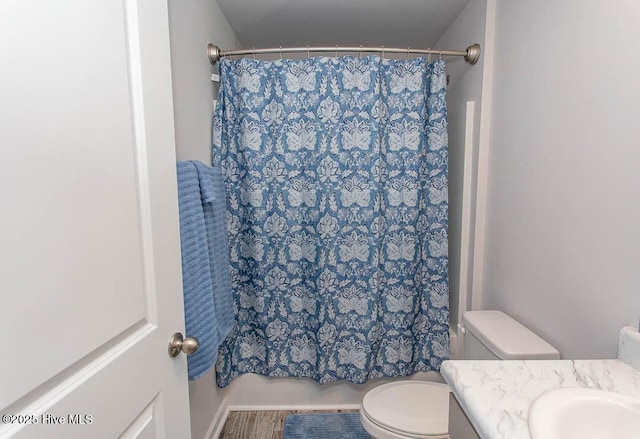 bathroom featuring toilet, vanity, and shower / bath combo with shower curtain
