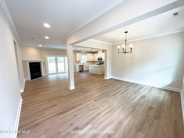 179 N Brightleaf Dr, Minnesott Beach, NC 28510 - unfurnished living room featuring a chandelier, crown molding, light wood-style flooring, recessed lighting, and baseboards