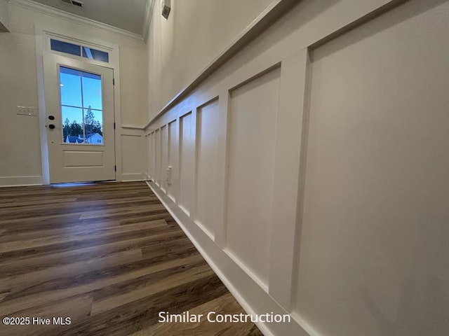 179 N Brightleaf Dr, Minnesott Beach, NC 28510 - entryway with crown molding, dark wood-style floors, and a decorative wall