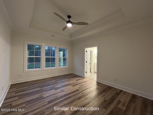 179 N Brightleaf Dr, Minnesott Beach, NC 28510 - empty room with a tray ceiling, crown molding, ceiling fan, dark wood finished floors, and baseboards