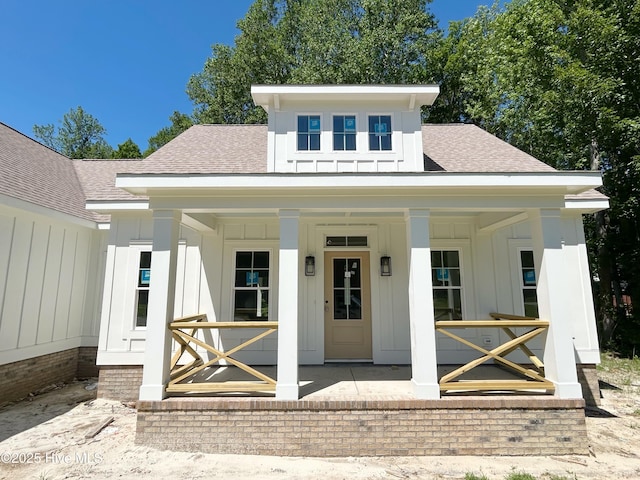 179 N Brightleaf Dr, Minnesott Beach, NC 28510 - bungalow with board and batten siding, a shingled roof, and covered porch