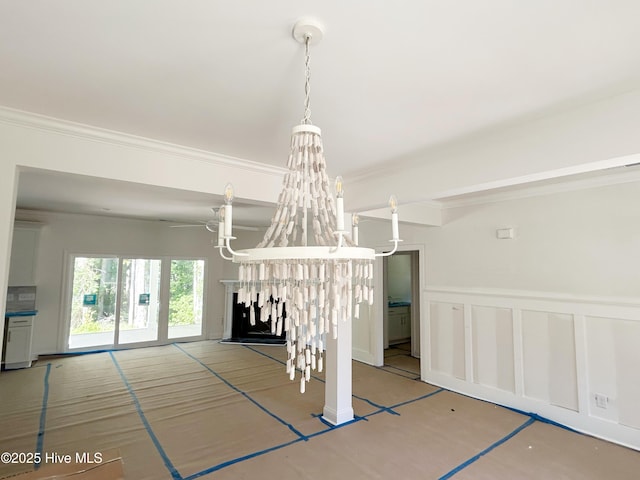179 N Brightleaf Dr, Minnesott Beach, NC 28510 - unfurnished dining area featuring a chandelier, crown molding, wainscoting, a decorative wall, and a ceiling fan