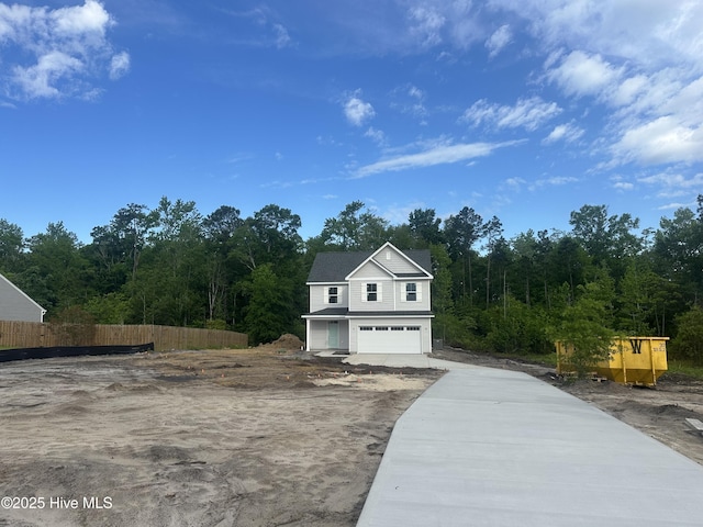 610 Poppleton Dr, Hampstead, NC 28443 - exterior space featuring concrete driveway, a view of trees, a garage, and fence