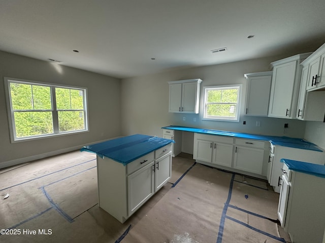 610 Poppleton Dr, Hampstead, NC 28443 - kitchen with white cabinetry and visible vents