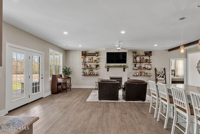 1560 White Oak River Rd, Maysville, NC 28555 - living area featuring baseboards, recessed lighting, ceiling fan, wood finished floors, and a glass covered fireplace