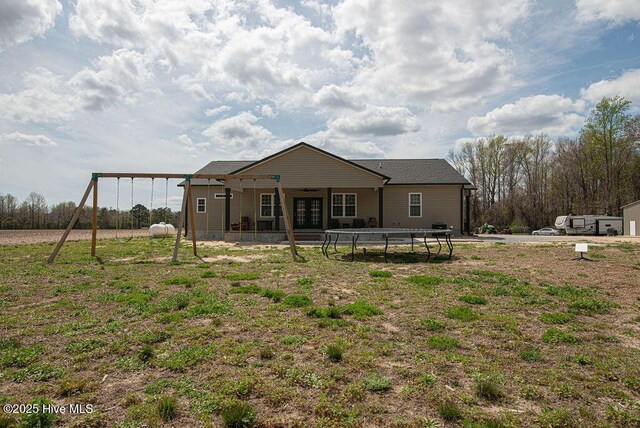 1560 White Oak River Rd, Maysville, NC 28555 - back of house featuring a playground, french doors, and a trampoline