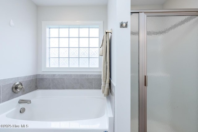 full bath with a garden tub and a stall shower