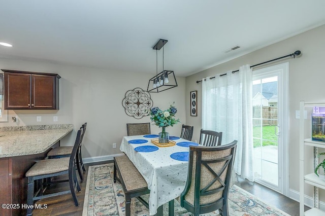 dining space featuring dark wood-style flooring, baseboards, and recessed lighting