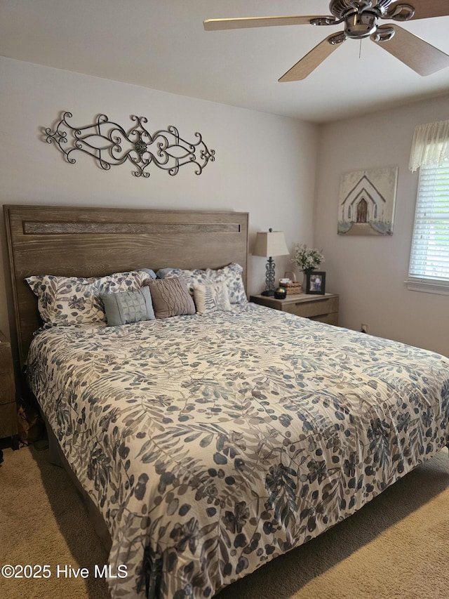 carpeted bedroom with a ceiling fan