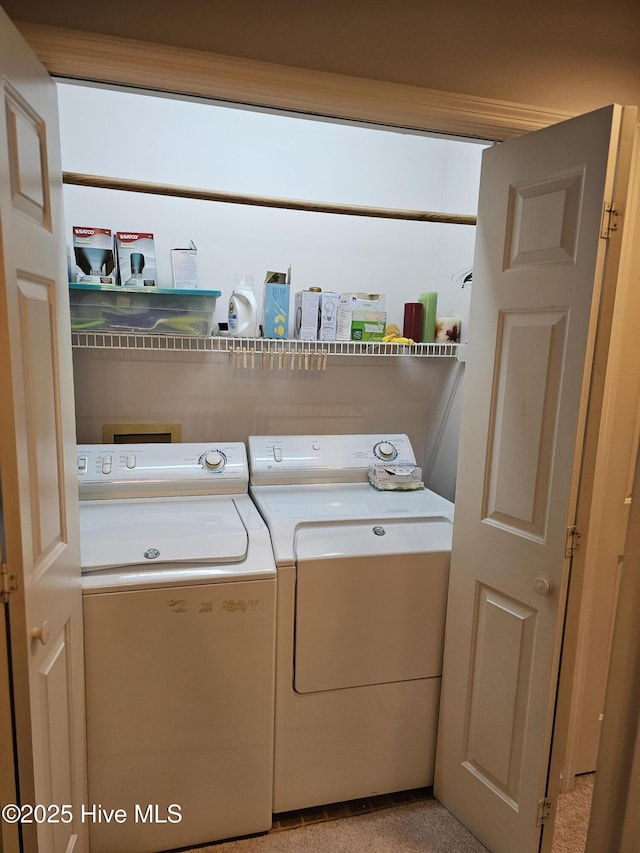washroom with separate washer and dryer and laundry area