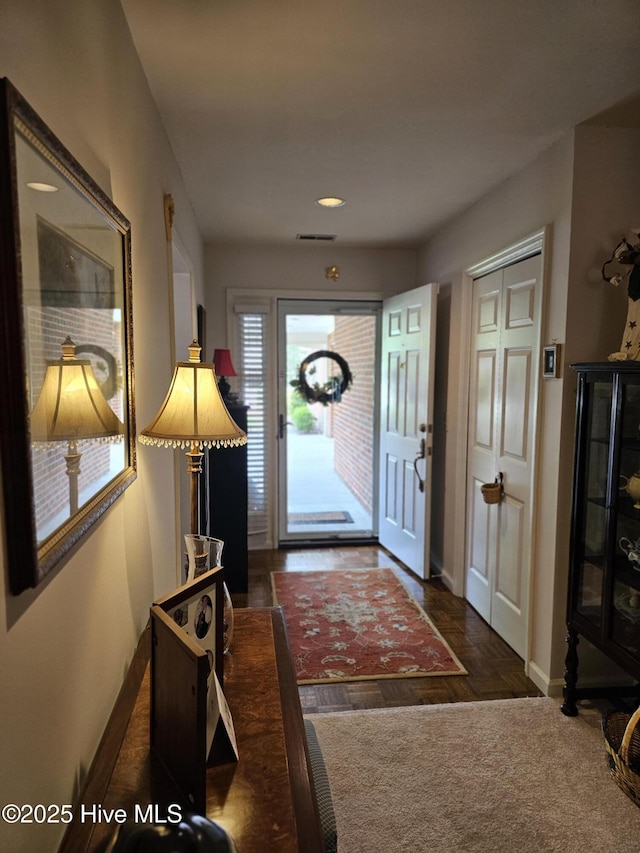 entryway with baseboards and visible vents