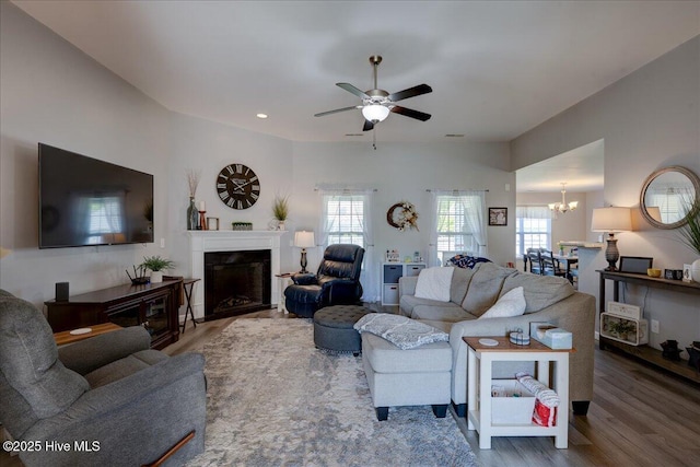 115 Kenmore Ct, New Bern, NC 28560 - living room with ceiling fan with notable chandelier, wood finished floors, a fireplace, and recessed lighting