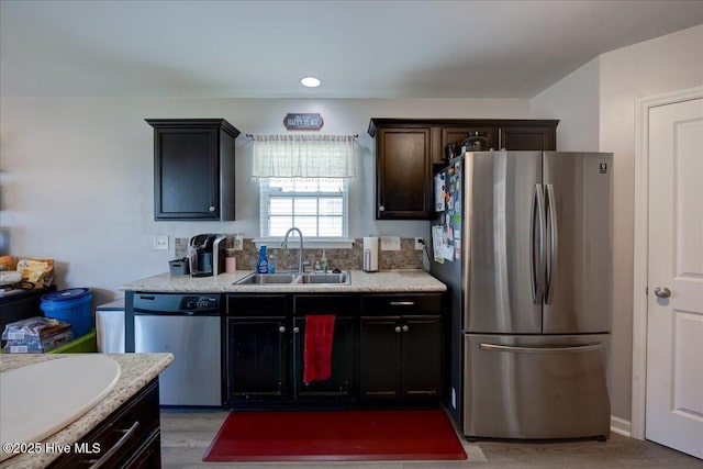 115 Kenmore Ct, New Bern, NC 28560 - kitchen with dark brown cabinets, a sink, light countertops, stainless steel appliances, and light wood-style flooring