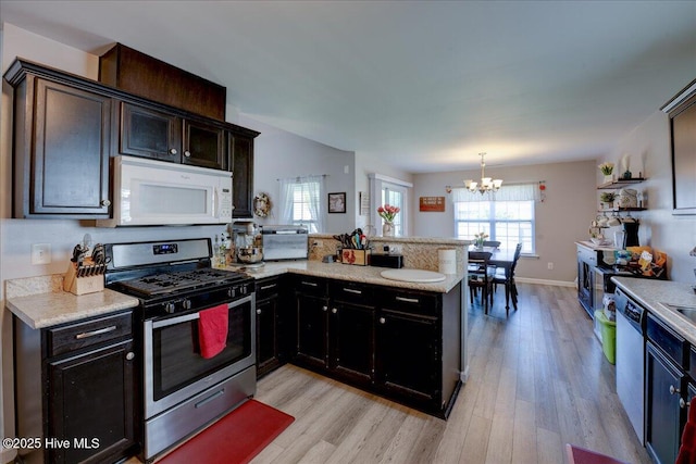 115 Kenmore Ct, New Bern, NC 28560 - kitchen featuring stainless steel range with gas cooktop, white microwave, light wood-style floors, a chandelier, and dishwashing machine