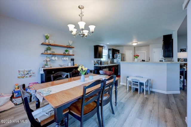 115 Kenmore Ct, New Bern, NC 28560 - dining space with light wood finished floors and a notable chandelier