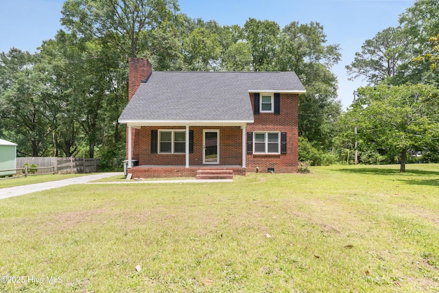 1507 Brookfield Rd, Rockingham, NC 28379 - view of front of house featuring covered porch, brick siding, a chimney, concrete driveway, and roof with shingles